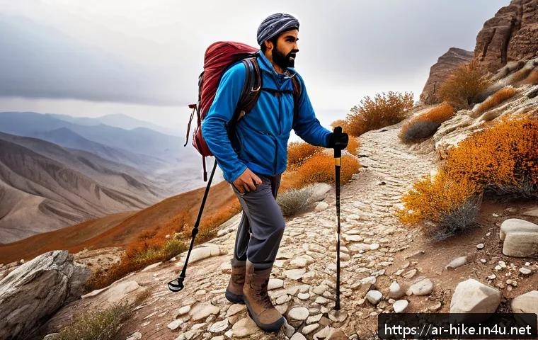 등산 스틱 꼭 필요한 이유 - A Middle Eastern man hiking on a rocky mountain trail during late autumn, wearing lightweight hiking...